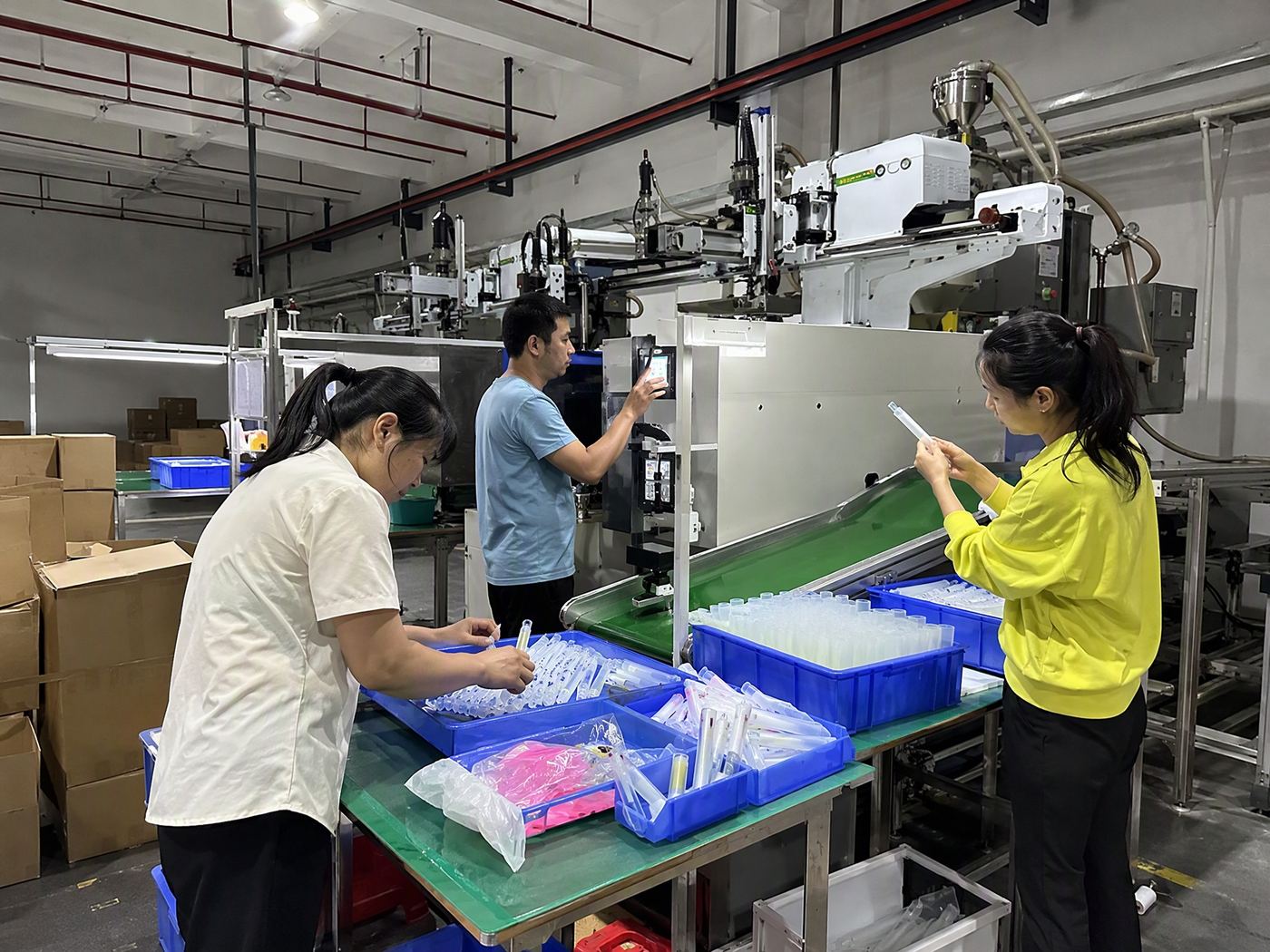 Two operators removing silicone parts from a compression moulding press