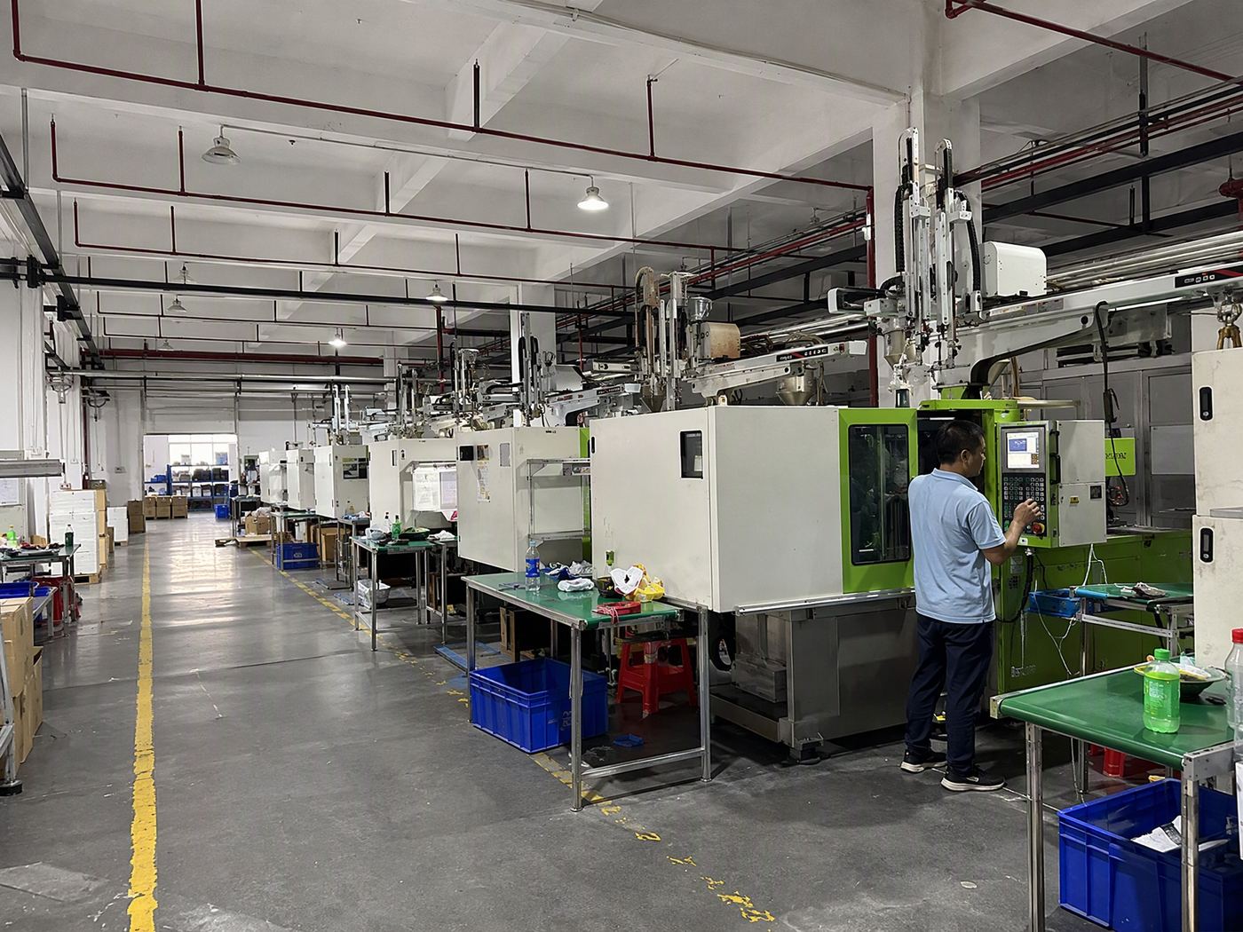 Injection moulding line with operators at machine control panels